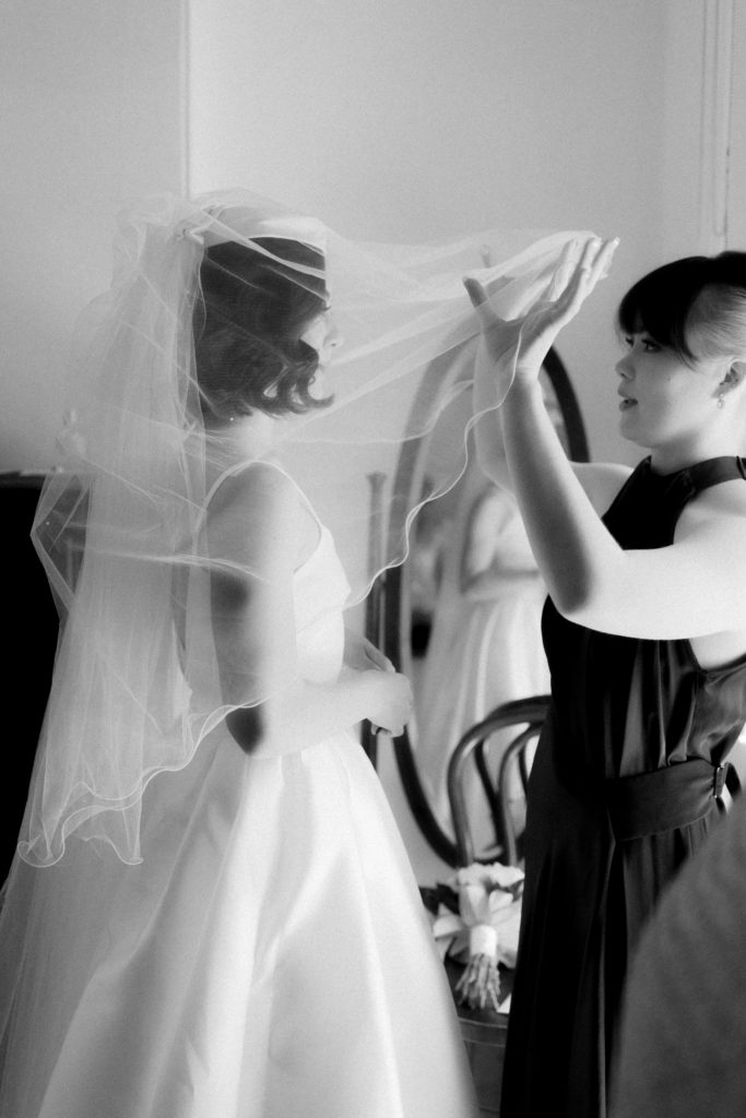 Sister helping women with her beautiful veil