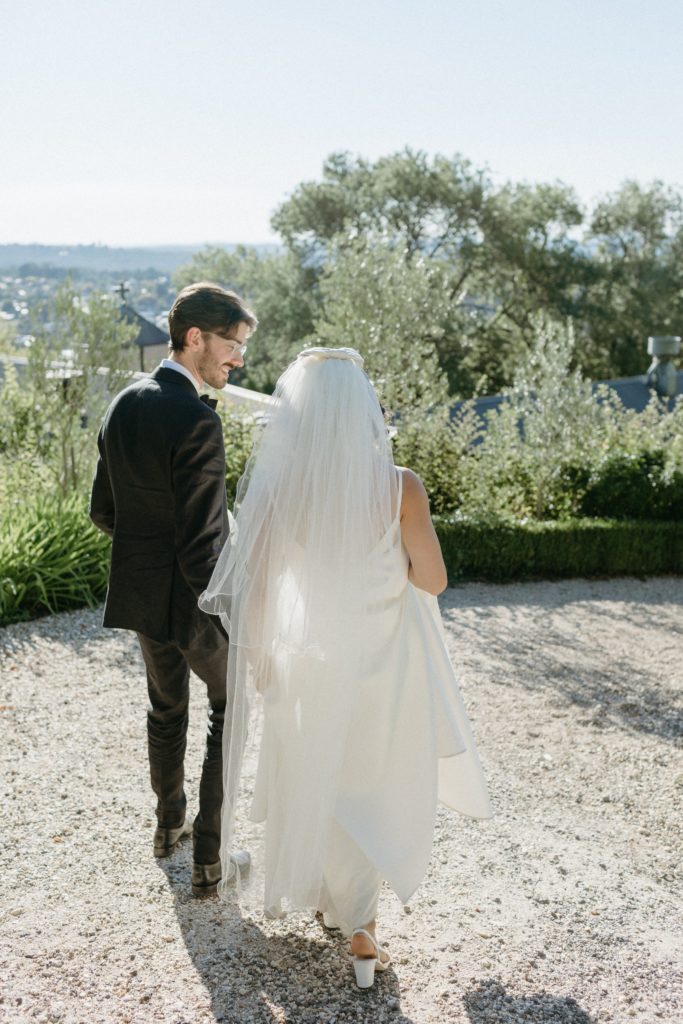 Contemporary wedding photography. Bride and groom walking together