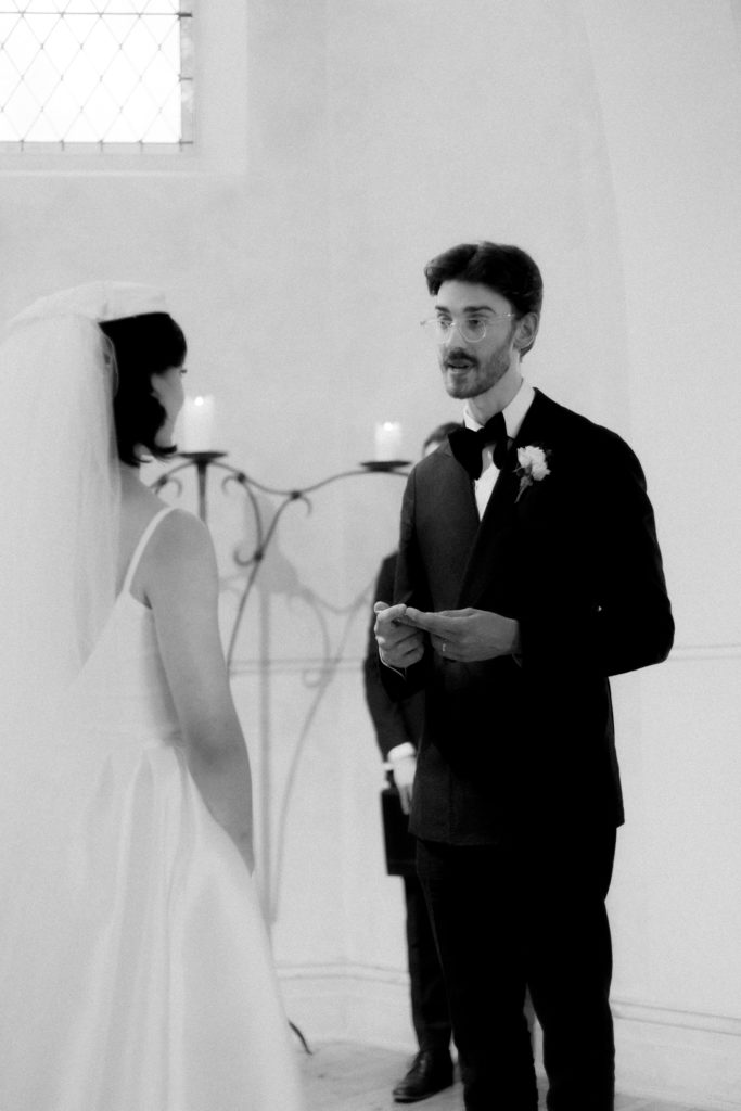 Groom reading vows during wedding ceremony 